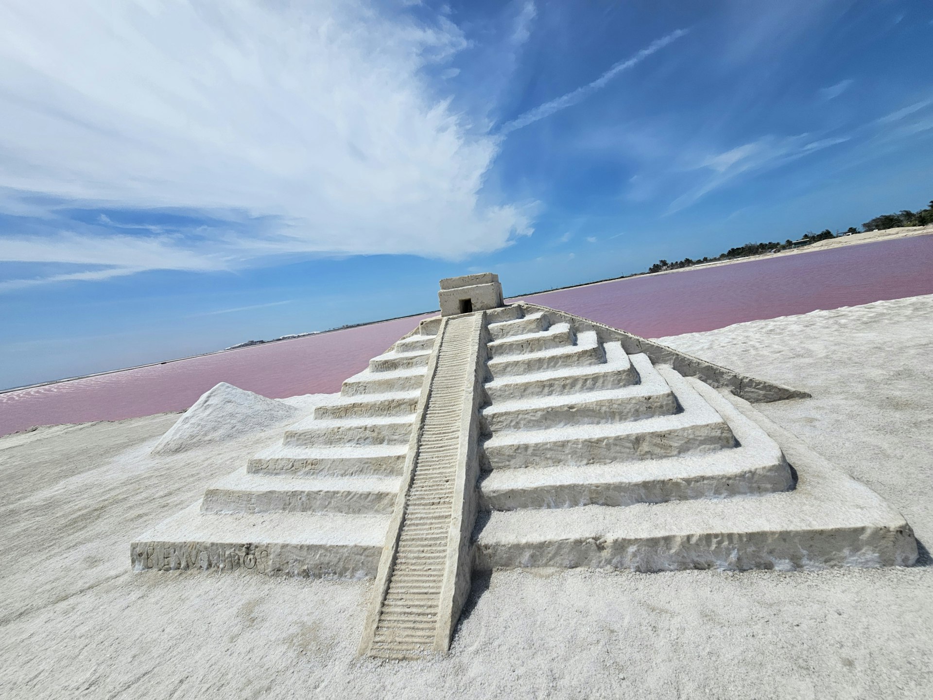 A concrete staircase in the sand on a beach